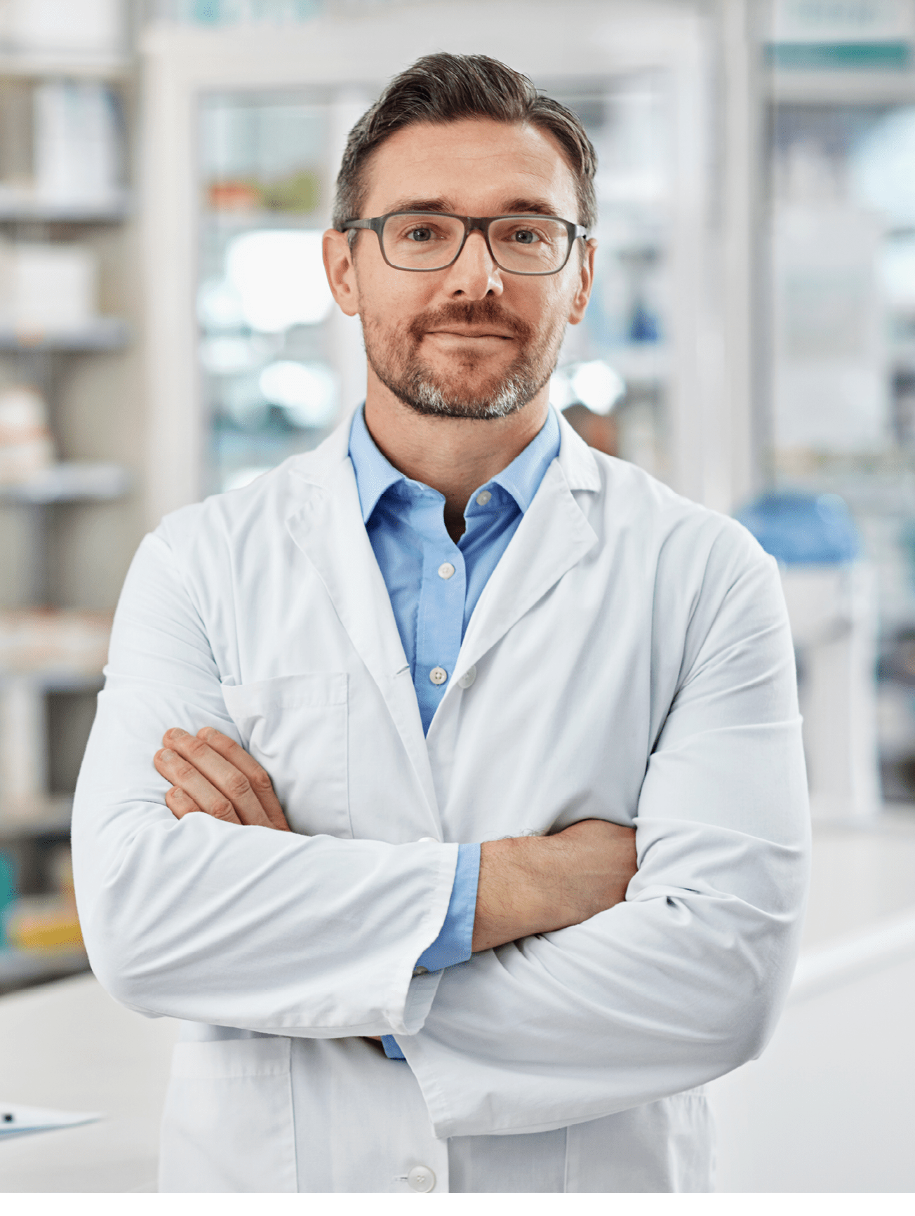 Portrait of a pharmacist standing with his arms crossed in a drugstore. All products have been altered to be void of copyright infringements