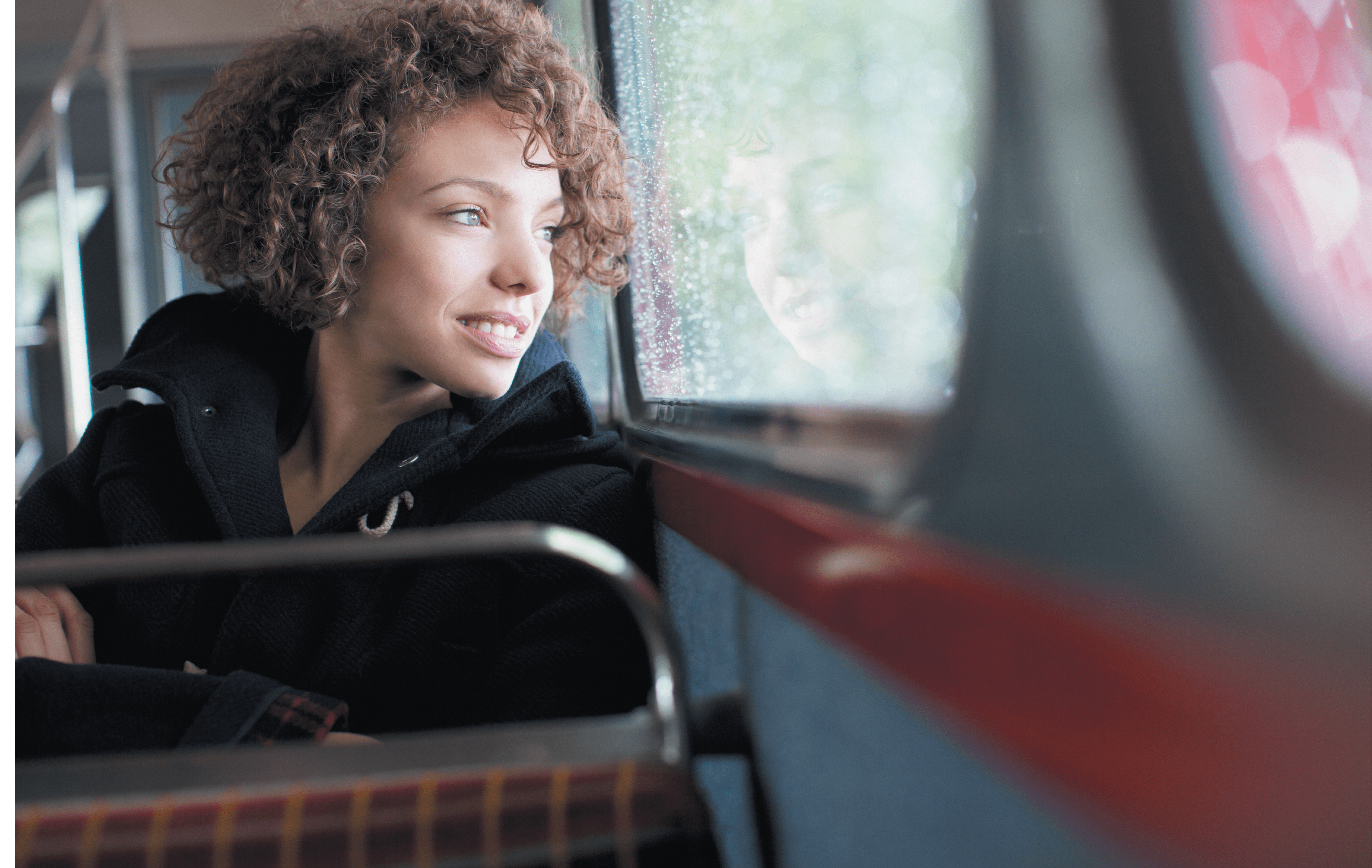 Smiling woman riding bus