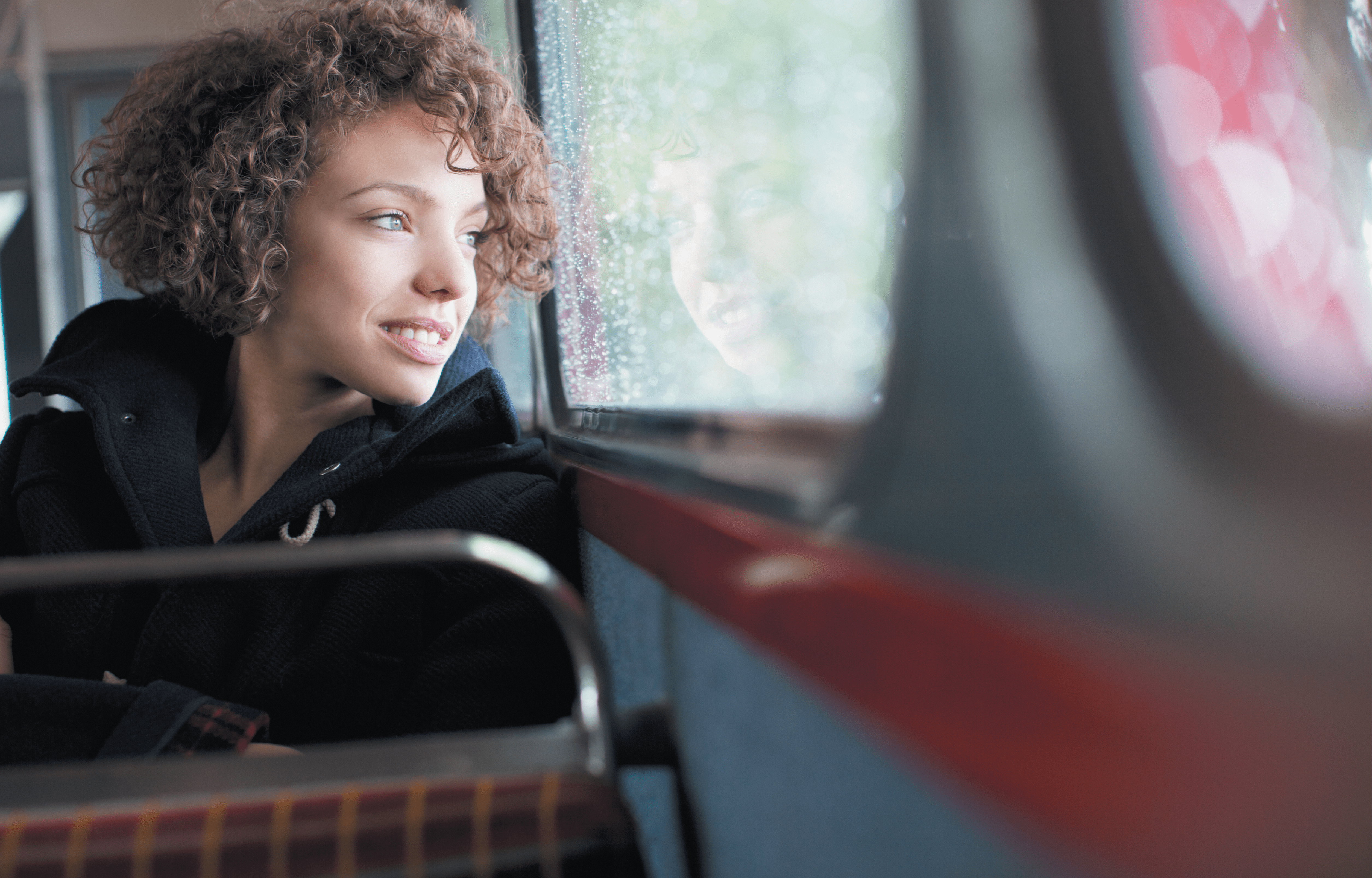 Smiling woman riding bus