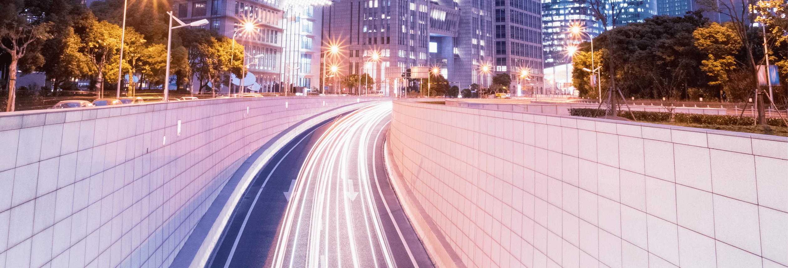 city tunnel road in nightfall with modern financial buildings at shanghai