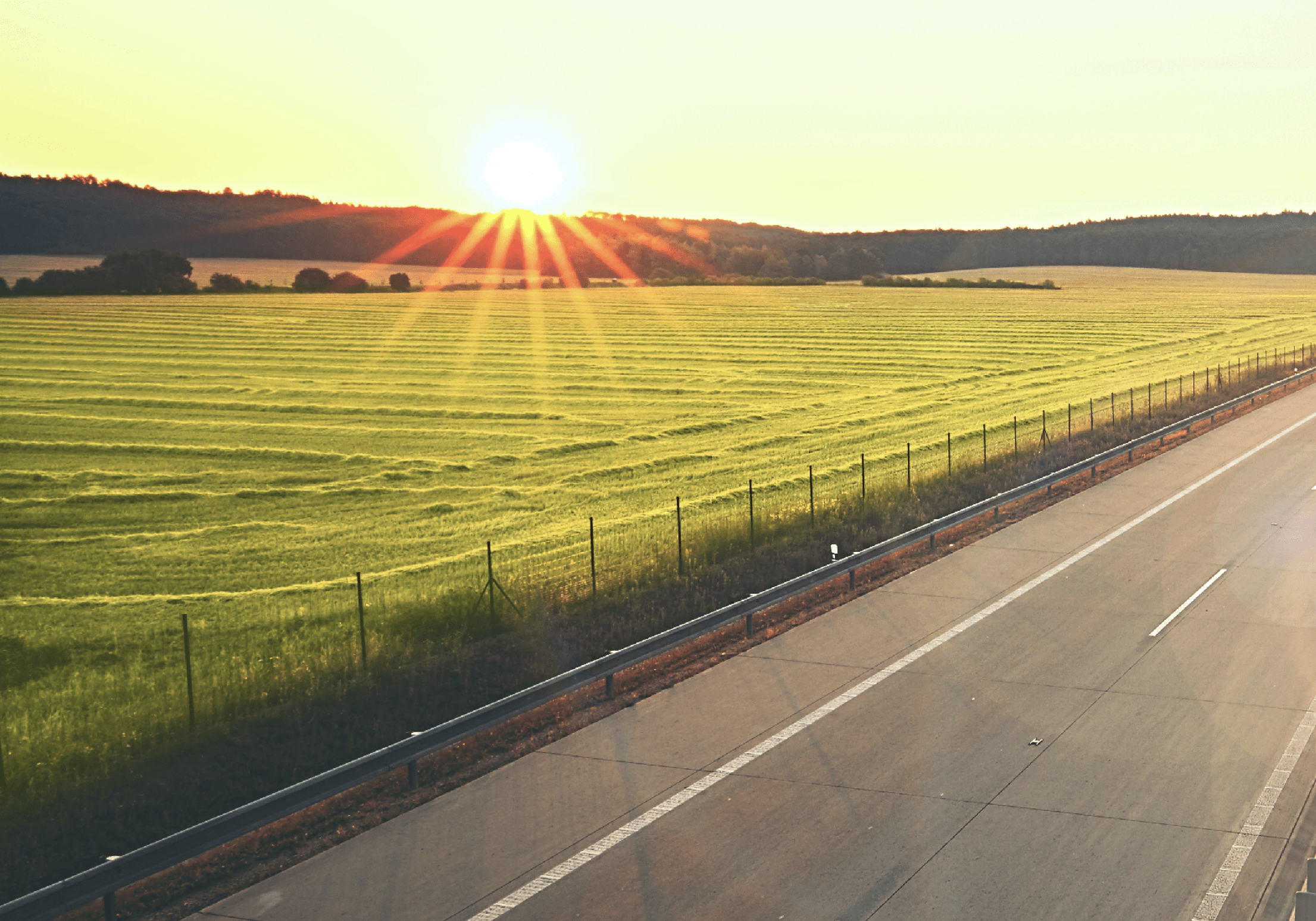 Traffic on the highway at the sunrise