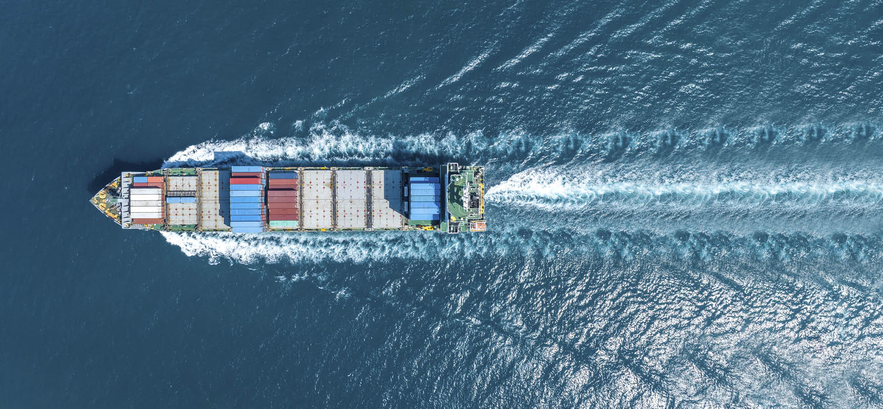 Cargo container Ship, cargo maritime ship with contrail in the ocean ship carrying container and running for export concept technology freight shipping sea freight by Express Ship. top view  