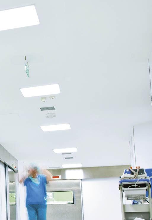 blurred figures wearing medical uniforms in hospital surgery corridor